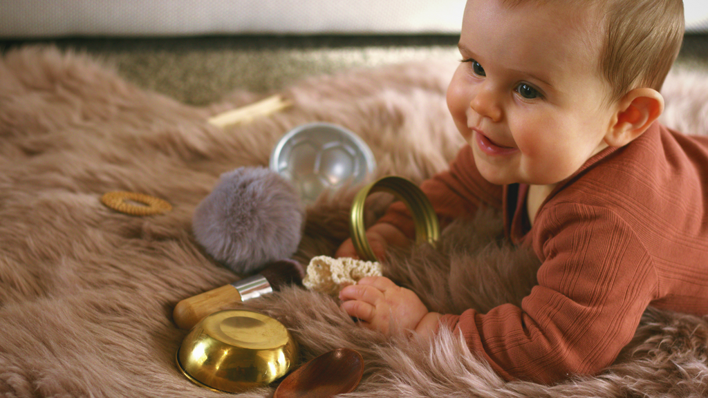Parent and child enjoying heuristic play together with wooden and metal objects. Educational, screen-free play that grows with your child.
