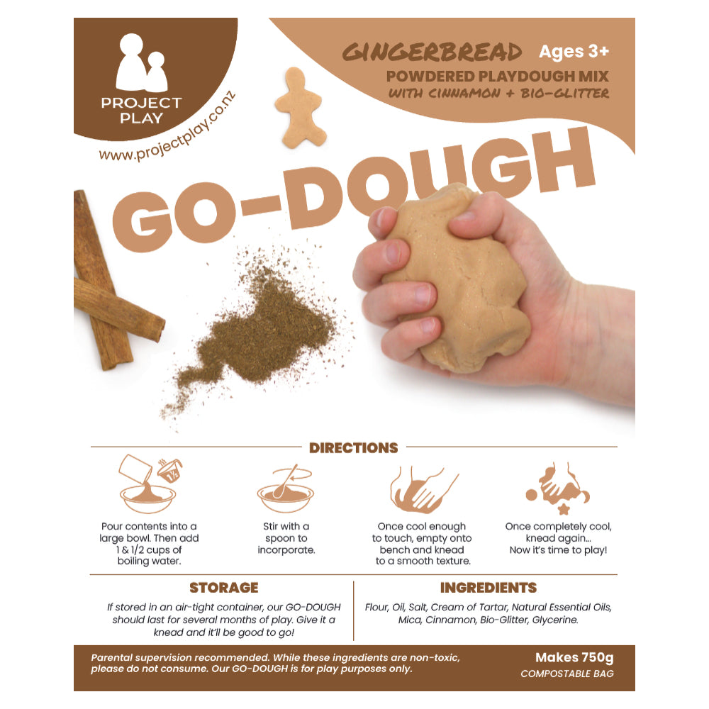 Powdered scented sensory playdough mix with a child's hand squeezing playdough